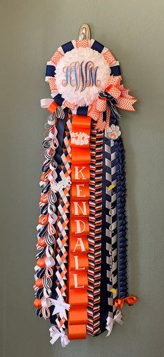 an orange ribbon hanging from the side of a wall