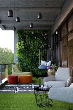 an outdoor living room with grass and plants on the wall, two chairs and a birdcage