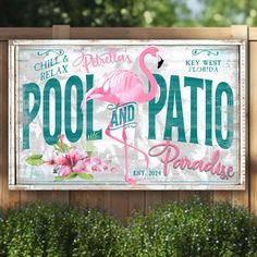 a pool and patio paradise sign in front of a wooden fence with flowers on it