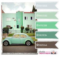 a car is parked in front of a house with green walls and white trims