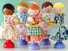 four dolls are standing next to each other