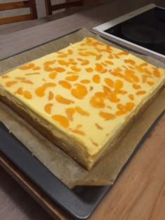 a cake sitting on top of a pan covered in frosting