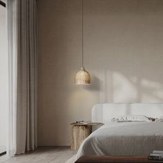 a white bed sitting next to a window in a room with wooden floors and walls