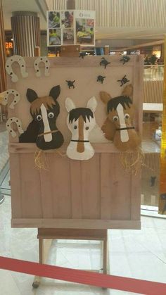 the horse heads are on display in the store's window, and it looks like they have been made out of wood