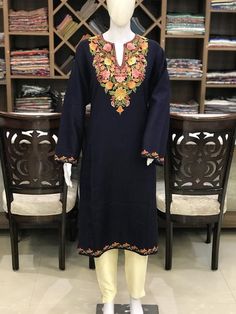 A stunningly marvellous Pheran. This Pheran features intricate Kashmir Aari embroidery on neckline and sleeves.- - - - - - - - - - - - - - - - - - - - Product Details- Condition: Brand New (made to order)- Style: Pheran Tunic- Fabric: Wool- Colour: Navy Blue- Embroidery: Aari Work- Embroidery Colour: Multi-Colour- Standard Length: 40" - Care Instructions: Dry Clean Only.**If you want the Tunic to be shorter or longer, just send us a message, and we will tailor it accordingly.Sizing- Please selec Pheran Kashmiri Dress, Kashmiri Phiran, Kashmiri Kurta, Kashmiri Dress, Straight Kurti Designs, Traditional Kurta, Embroidery Fashion Detail, Indian Kurta, Cotton Kurti Designs