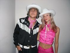 a man and woman dressed up in cowboy hats