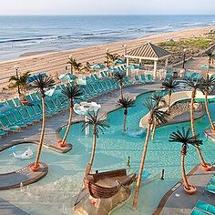 an aerial view of a resort pool and beach