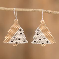 Want to take the Christmas tree everywhere you go? Then try this pair of adorable beaded dangle earrings shaped like one of the most iconic holiday symbols. Guatemalan artisan Mirian Zet threads glass beads in gold, ivory and black onto nylon cords that hang from gleaming sterling silver hooks in a design that is classic and modern at the same time. Holiday Symbols, Modern Christmas Tree, Handmade Christmas Tree, Buy Bead, Beaded Dangle Earrings, Modern Christmas, Halloween Christmas, Beaded Dangles, Hook Earrings