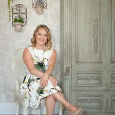 a woman sitting on a chair in front of a door