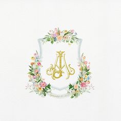 the initial monogram is surrounded by floral wreaths and gold letters on a white background