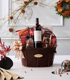 a wine basket filled with lots of holiday goodies