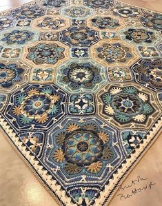 a large blue and white rug on the floor