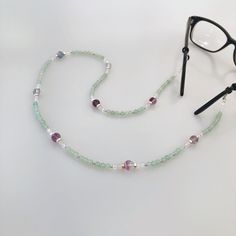 The Return to Origin Aventurine Beaded Necklace is a versatile and stylish piece of jewelry. It features natural aventurine and fluorite beads, as well as sterling silver beads, clasps, and rings. The necklace also includes white crystals and jade beads, and has a beaded chain that measures 28 inches. The necklace comes with white glasses chain connectors, allowing you to wear it in a variety of styles. The set also includes an Auspicious Origin Pendant made of sterling silver, with baroque pear Elegant Adjustable Amazonite Beaded Necklaces, White Glasses, Fluorite Necklace, Aventurine Necklace, Classic Necklace, White Crystals, Glasses Chain, Rope Necklace, Jade Beads