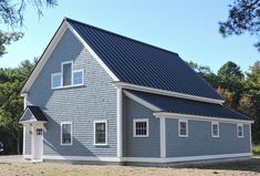 a gray house with a black roof and white trim