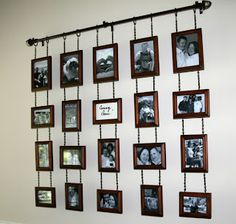 a bunch of pictures hanging on a wall with chains attached to the side of it