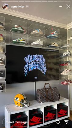 a football helmet and other sports memorabilia are on display in a room with clear acrylic shelves