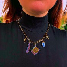 This 'The Craft' charm necklace boast five spellbinding avant-garde charms which capture the vibes of the greatest witchy story of all time. The piece, inspired by the '90s smash hit movie, is made from 18K gold plated chain necklace and boasts five dazzling charms. In the centre is a magical spell book, surrounded by a beautiful opal quartz, a unique purple feather charm, a moon and a snake. The chain fastens at the back with a lobster claw clip. It is an unusual yet pretty piece which is bound Purple Feather, Feather Charms, Spell Book, The Craft, Gold Plated Chains, Matching Earrings, Halloween Shopping, Charm Necklace, Necklace Etsy