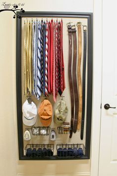 a rack with ties and other items hanging on it's wall in front of a door