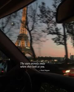 the eiffel tower seen from inside a car at night, with text overlaying it