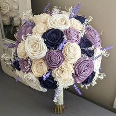 a bridal bouquet with purple and white flowers