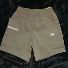 New Never Worn Above Knee Standard Fit Deep Pockets And Zipper Pocket Nike Shorts With Pockets In Solid Color, Nike Casual Shorts With Cargo Pockets, Nike Casual Shorts With Pockets, Casual Nike Shorts With Pockets, Casual Khaki Sports Shorts, Casual Khaki Shorts For Sports, Nike Casual Beige Bottoms, Boys Nike Shorts, Nike Basketball Shorts