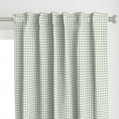 a green and white checkered curtain hanging on a window