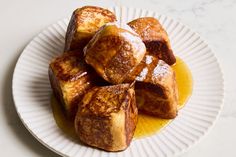 a white plate topped with french toast covered in powdered sugar