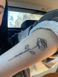 a woman with a rose tattoo on her arm