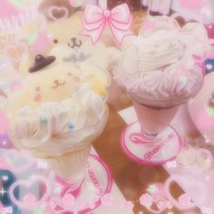 two cupcakes with white frosting and bows on them are surrounded by hearts