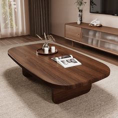 a living room with a large wooden coffee table in front of a flat screen tv