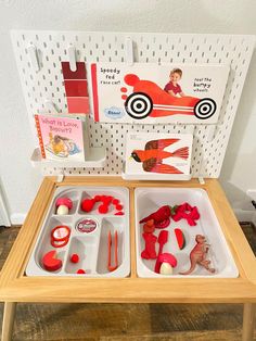 a wooden table with two trays filled with toys