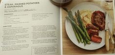 a plate with meat, mashed potatoes and asparagus next to a cup of coffee