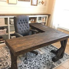 a desk with a chair in front of it on a rug and shelves behind it