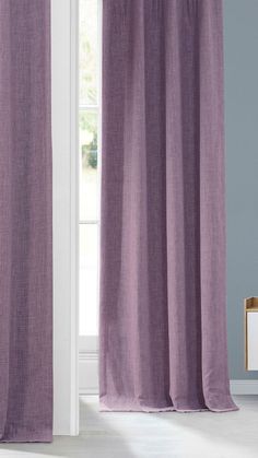 a purple curtain hanging in front of a window