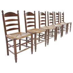 six wooden chairs with woven seat cushions