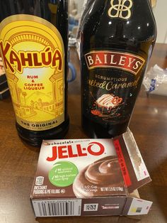 two bottles of bailey's and a box of jello sitting on a table