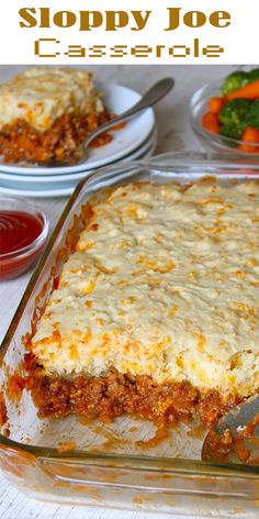 a casserole dish with meat and cheese in it on a table next to other dishes