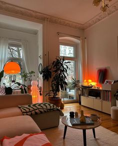 a living room filled with furniture and lots of windows