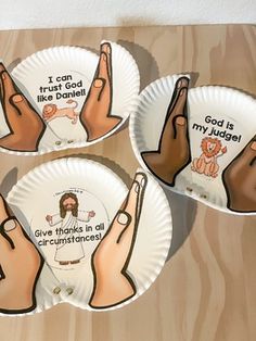 four paper plates with hand gestures on them