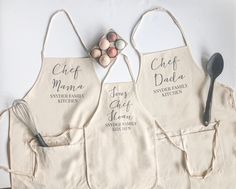 three personalized aprons with eggs and spoons on them, sitting next to each other