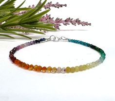 This colorful, dainty beaded bracelet is made with tiny 2mm faceted round gemstone beads in a rainbow of gorgeous colors! The gemstones are arranged in an ombre shaded pattern, and include a variety of semi-precious stones and crystals carefully strung on flexible aluminum wire. Perfect for celebrating or showing your support for Pride, or just for those who love rainbows and colorful jewelry! This piece can also be made as an anklet or necklace, just select the length you prefer or message us w Rainbow Crystal Bracelet With Gemstone Round Beads, Rainbow Crystal Bracelet With Round Gemstone Beads, Rainbow Faceted Round Beads Bracelets, Spiritual Multicolor Faceted Beaded Bracelets, Rainbow Faceted Beads Bracelet As Gift, Rainbow Faceted Beads Bracelet For Jewelry Making, Rainbow Beaded Bracelets With Faceted Beads For Gift, Rainbow Faceted Beads Bracelets, Multicolor Faceted Rondelle Bracelets