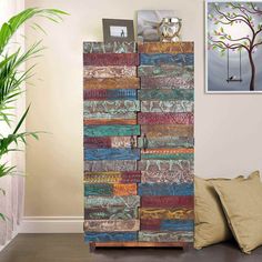 a tall wooden cabinet sitting next to a plant