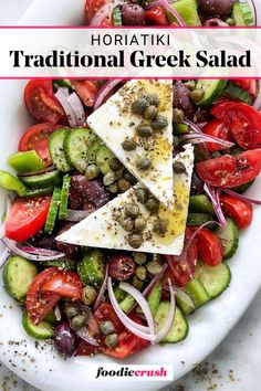 a white plate topped with sliced up vegetables next to a bowl of olives and tomatoes