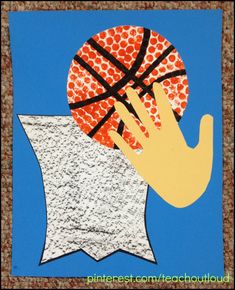 a hand holding a basketball over a piece of paper