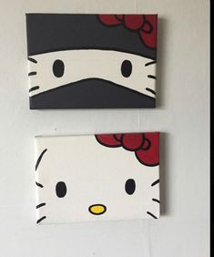 two hello kitty paintings are hanging on the wall