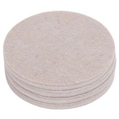 four round wool coasters stacked on top of each other in front of a white background