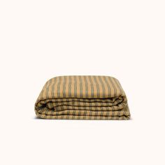 a yellow and brown striped blanket on a white background