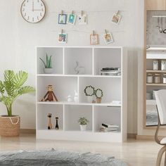 a living room filled with furniture and a clock above the bookshelf on the wall