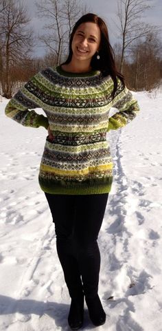 a woman standing in the snow with her hands on her hips