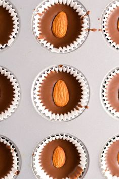 chocolate cups with almonds in them are lined up